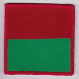 A red and green square patch on a white surface.