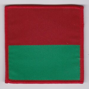 A red and green square patch on a white surface.