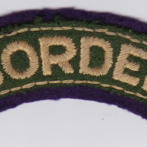 A green and purple border patch on a white surface.