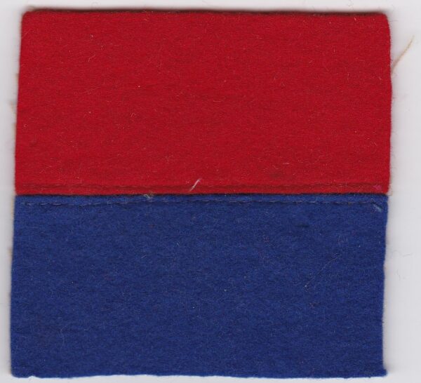 A red and blue felt square on a white surface.