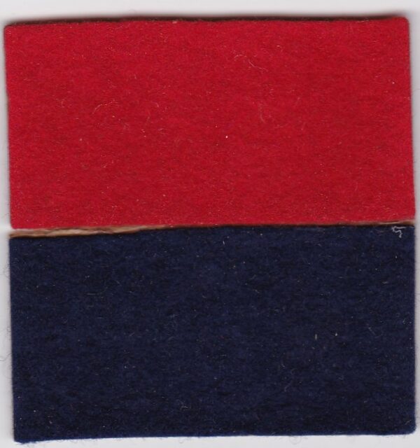 A red and black felt square on a white surface.