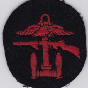 A red and black badge with an eagle and a gun.