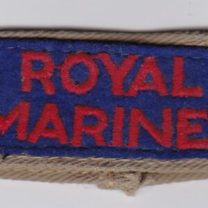 A royal marines badge on a white surface.