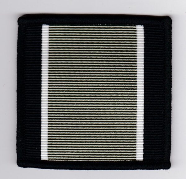 A black and white striped patch on a white surface.