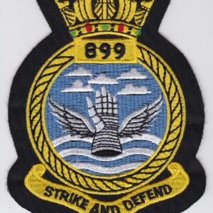 A badge with the words strike auto defend embroidered on it.