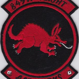 A red and black patch with an image of an armadillo.