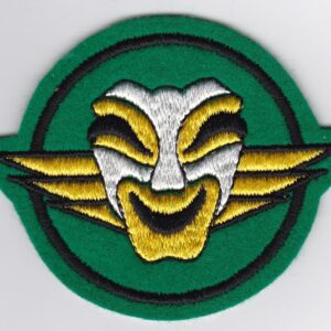 A green and yellow patch with a face on it.