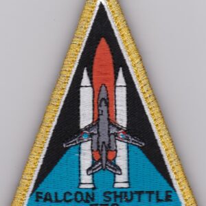 A patch with the falcon shuttle logo on it.