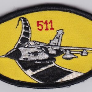 A yellow and black patch with an image of a fighter jet.