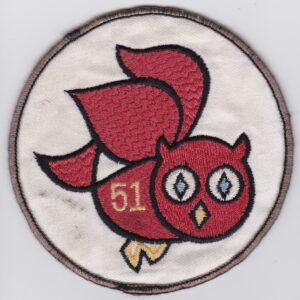 A red patch with an owl on it.