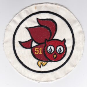 A red owl embroidered on a white patch.