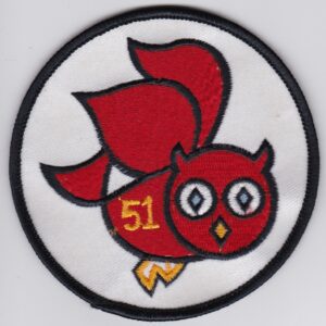 A red owl embroidered on a white patch.