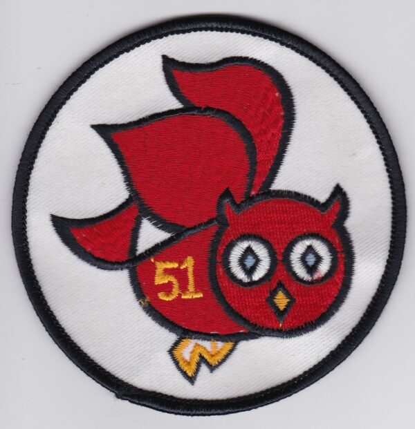 A red owl embroidered on a white patch.