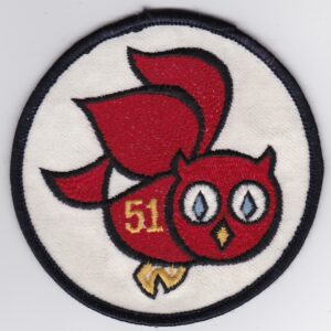 A red patch with an owl on it.