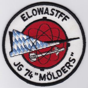 A red and white patch with a black text and a black and white flag.