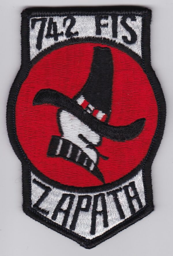 A red and black patch with a face and hat.