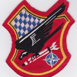 A red and white patch with an eagle on it.