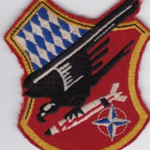 A red and white patch with an eagle on it.