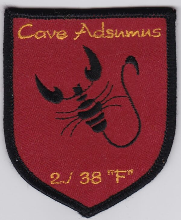 A red and black patch with a scorpion on it.