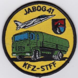 A patch with an image of a truck and a green truck.