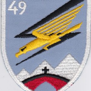 A patch with a plane flying over a mountain.