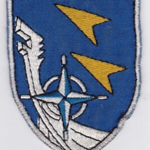 A blue and white patch with a compass and an arrow.