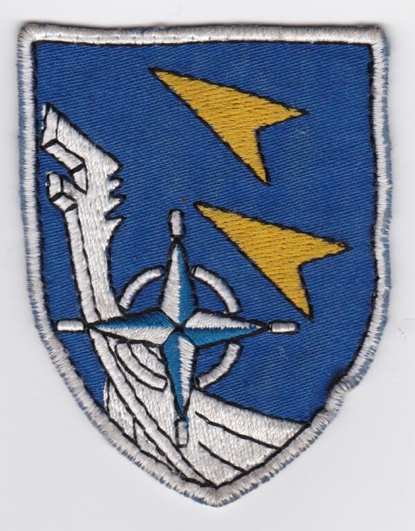 A blue and white patch with a compass and an arrow.