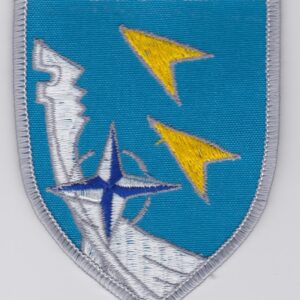 A blue and white patch with a yellow and blue arrow on it.