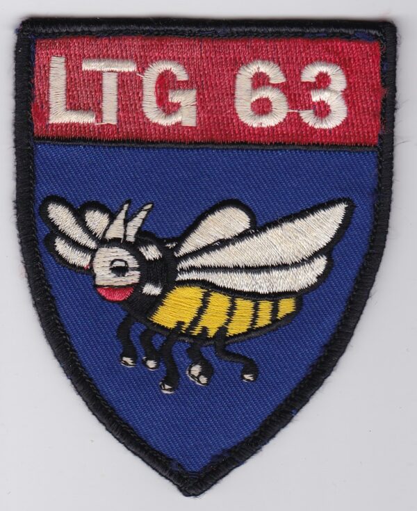 A blue and red patch of LTG 63 with a bee on it.