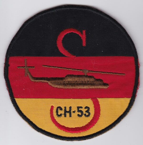 A patch with a german flag and a helicopter on it.