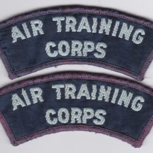 Two air training corps patches on a white surface.