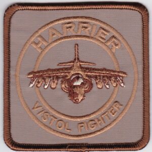 A brown patch with the word harrier visto fighter on it.