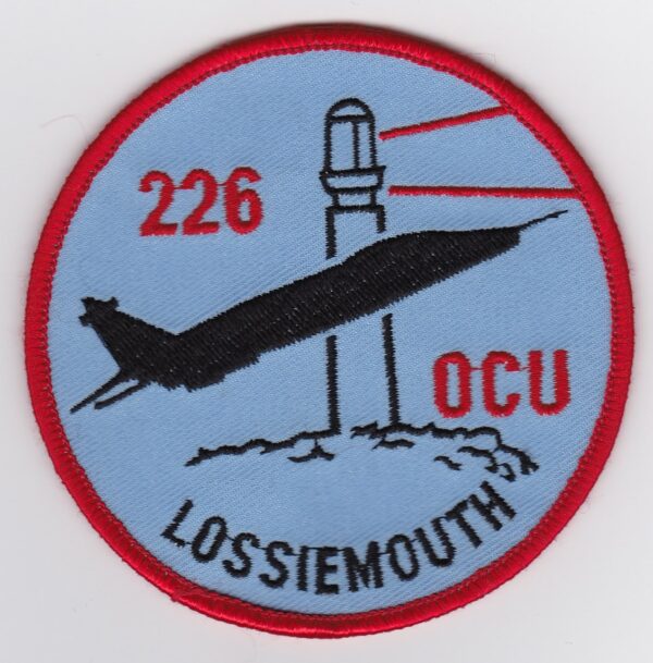 A patch with an image of a jet and a lighthouse.