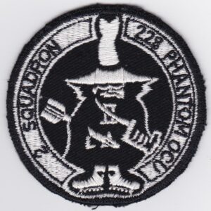 A black and white patch with a hat on it.