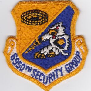 An air force security group patch on a white surface.