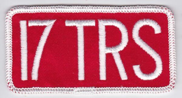 A red and white patch with the word 17 trs on it.