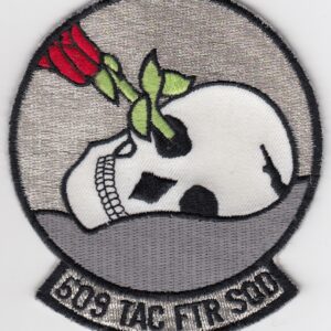 A patch with a skull and roses on it.