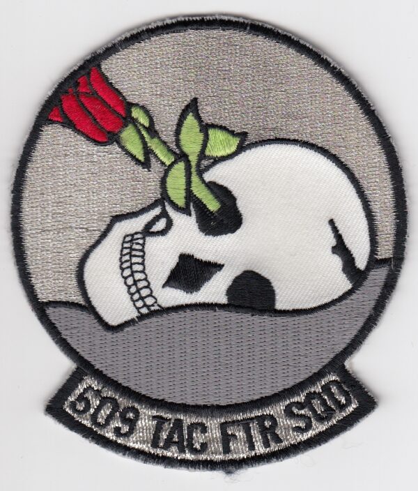 A patch with a skull and roses on it.