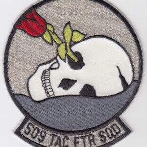 A patch with a skull and a rose on it.