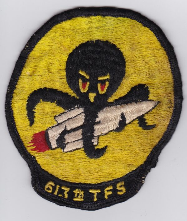 A patch with an octopus holding a rocket.