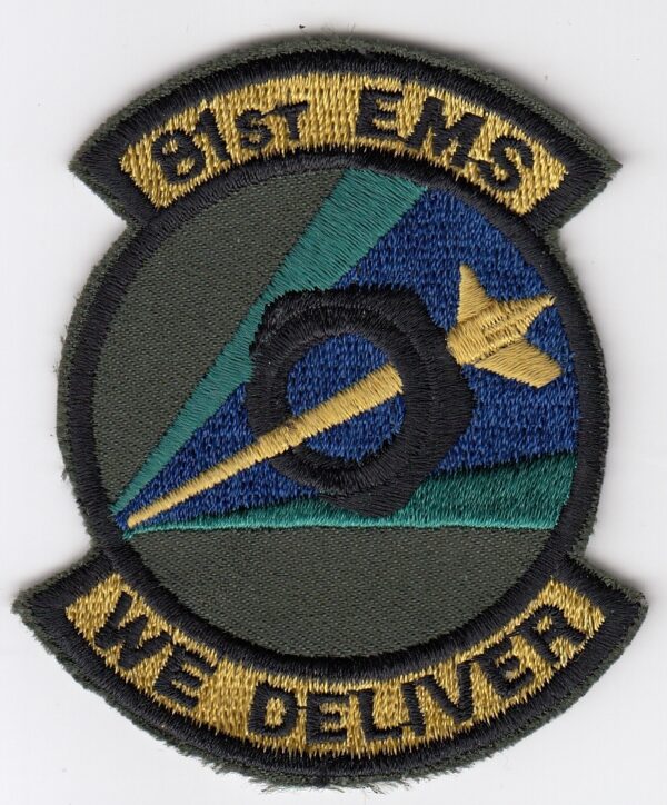 A patch with the words bt ems we deliver.