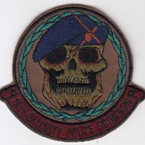 A patch with a skull and beret on it.