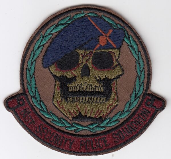 A patch with a skull and beret on it.