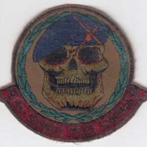 A patch with a skull and beret on it.