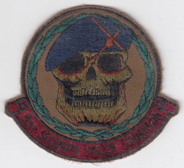 A patch with a skull and beret on it.