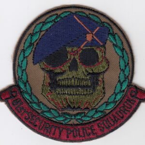 A patch with a skull and beret on it.