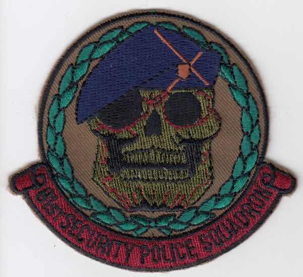 A patch with a skull and beret on it.