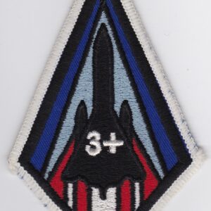 A patch with a red, blue, and white design on it.