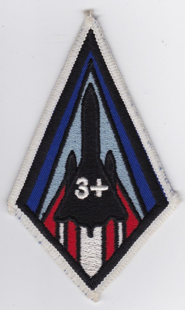 A patch with a red, blue, and white design on it.