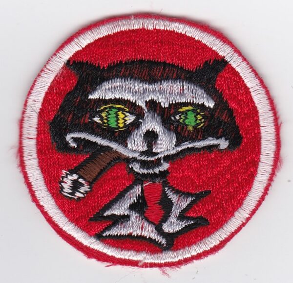 A red patch with an image of a raccoon on it.